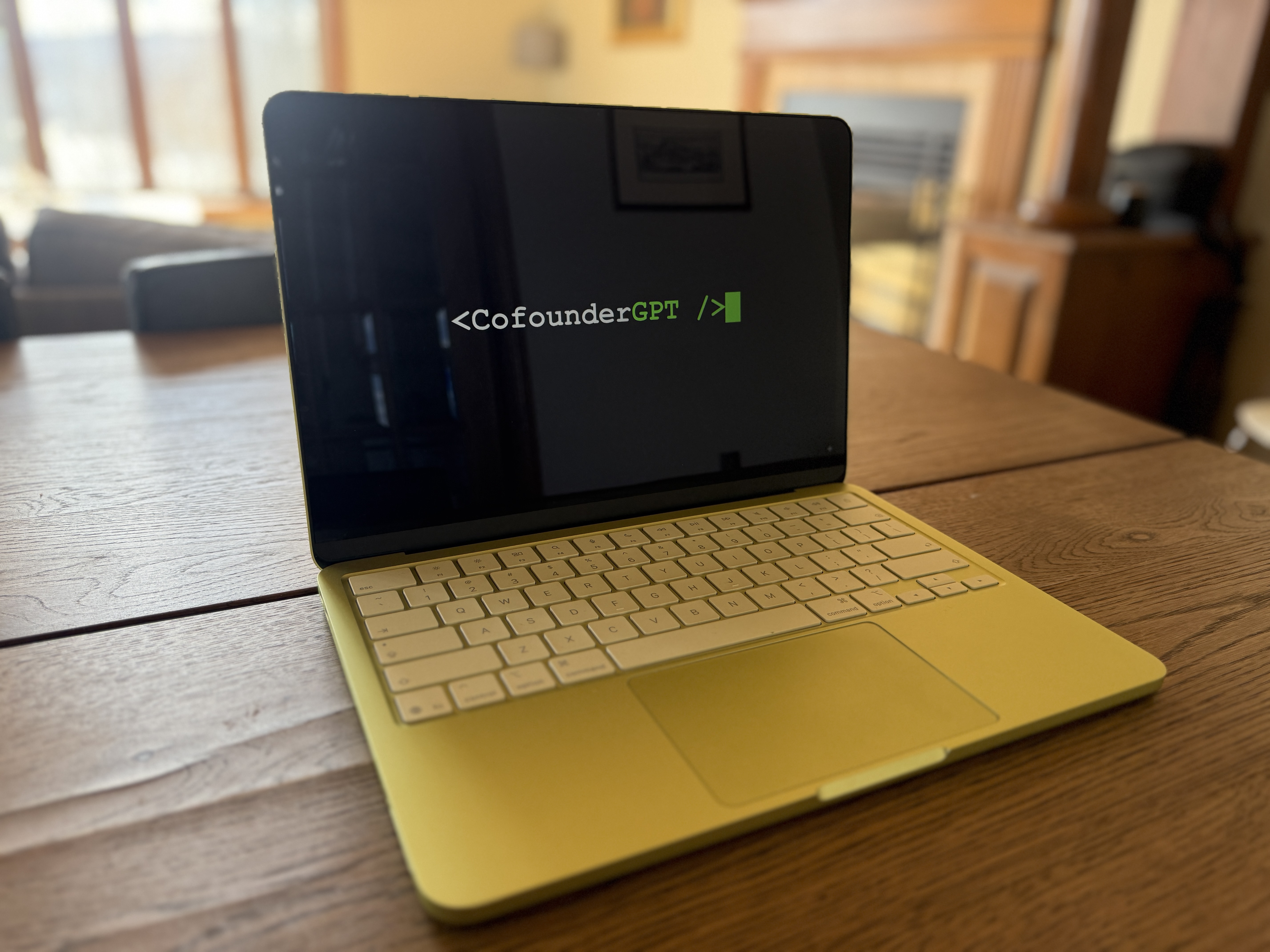 The lime-green MacBook Neo running CofounderGPT