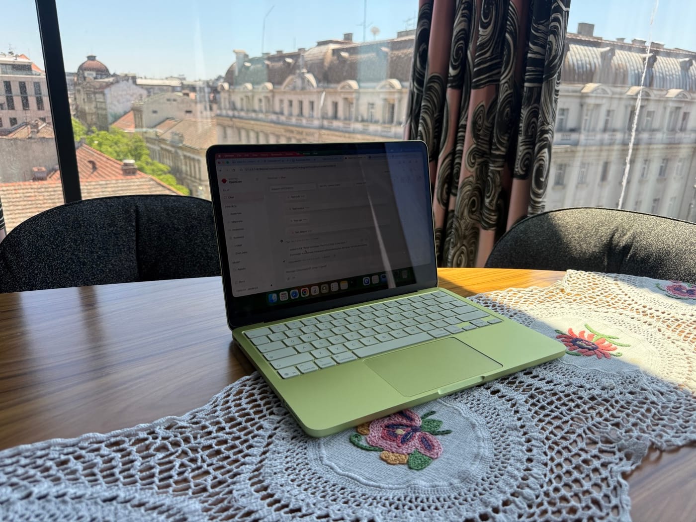 Lime green MacBook running CofounderGPT on a table at Mama Shelter in Belgrade